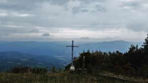 Cross on a hill overlooking the valley Apennine Mountains Italy